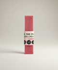 Pink dog chew with label on a light gray background