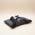 Gray heating pad with sherpa trim on a beige background