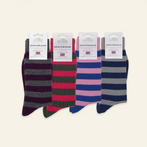 Four pairs of striped socks with labels on a white background