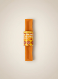Orange dog chew treat with a label on a beige background
