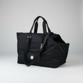 Black bag with a strap on a light gray background