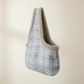 Plaid-patterned bag with a textured edge on a beige background