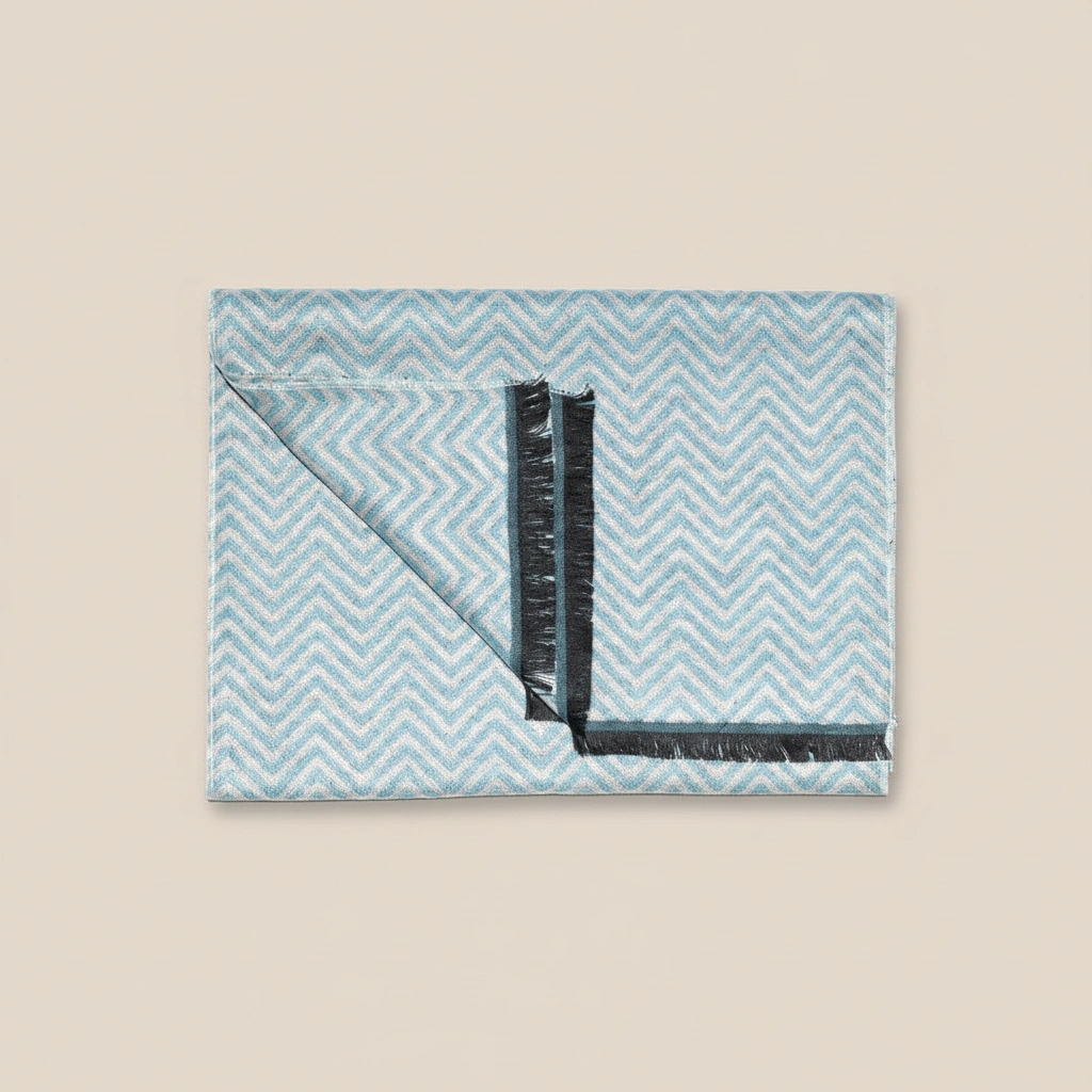 Folded fabric with blue chevron pattern on a beige background