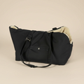 Black bag with beige interior on a beige background