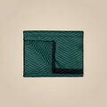 Green and black patterned fabric on a beige background