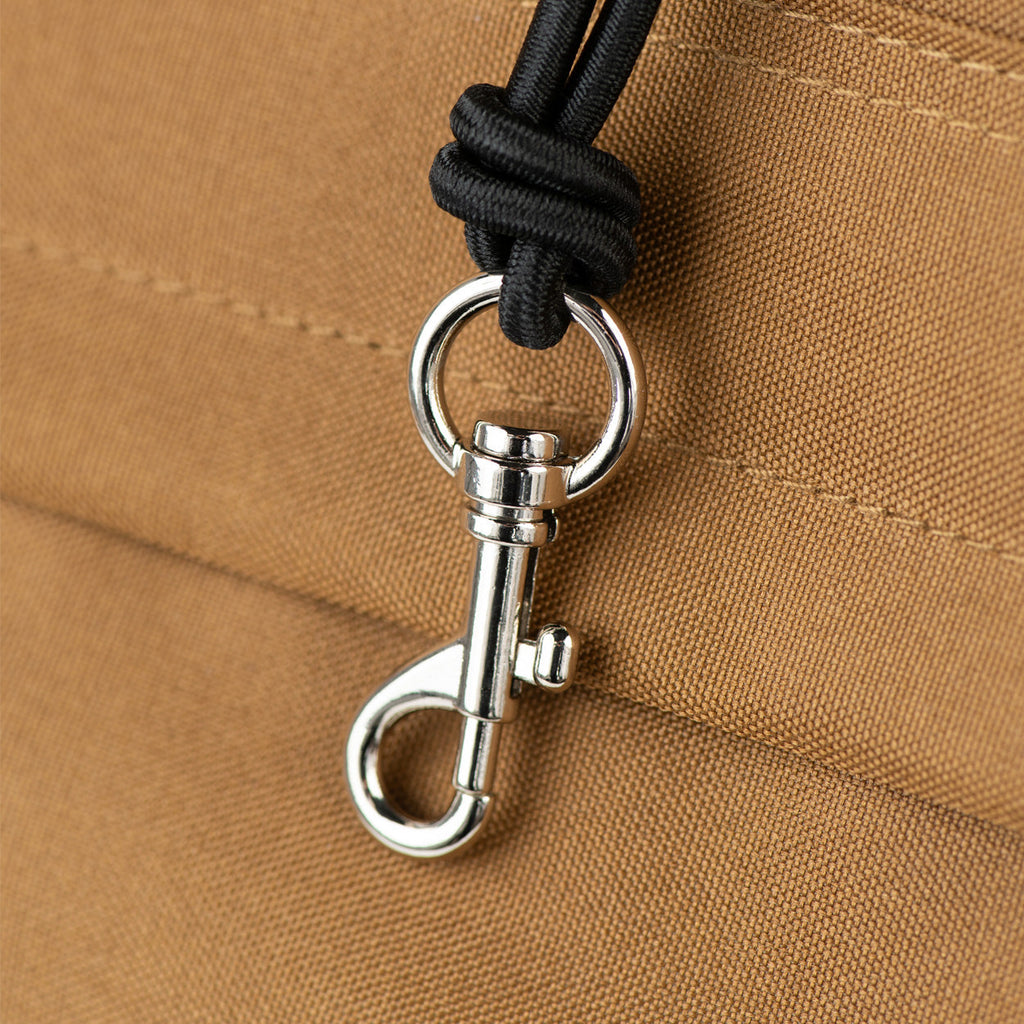 Close-up of a metal clasp on a brown fabric background