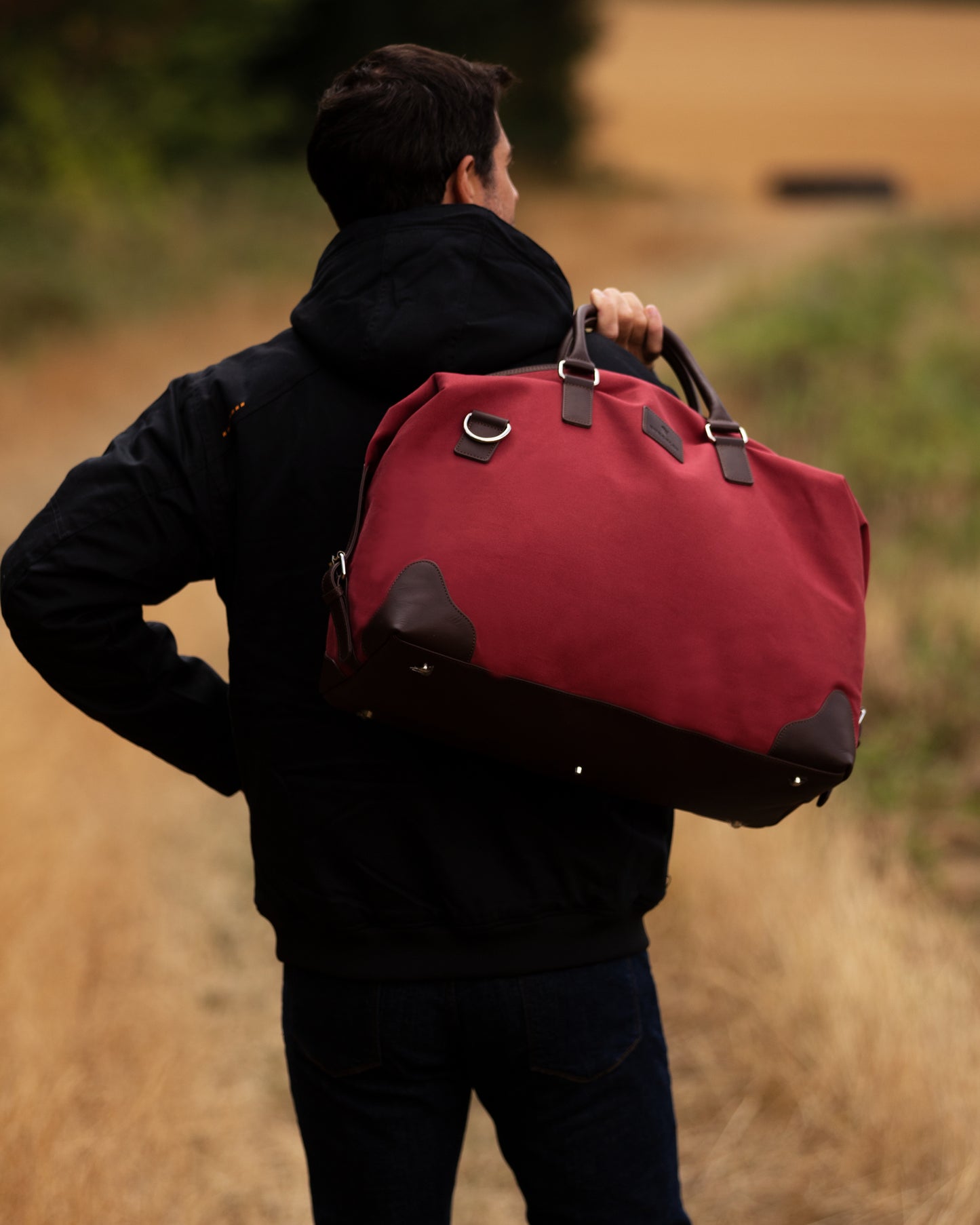 Handmade red cotton canvas and vegetable tanned leather holdall by Burghley Bags.