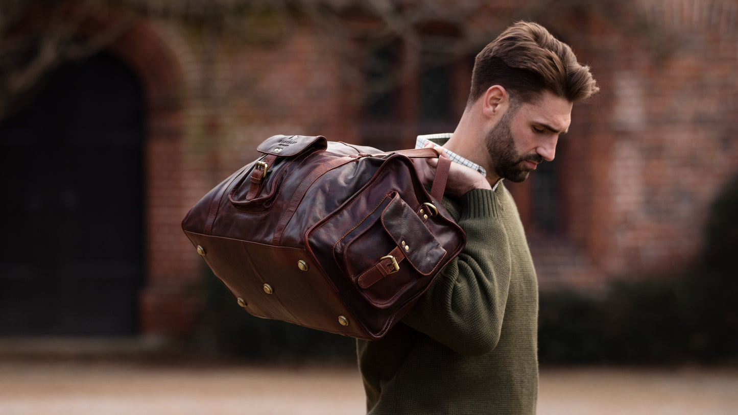 Brown full leather rugged holdall in classic English country style. Handmade from full grain vegetable tanned cow leather.