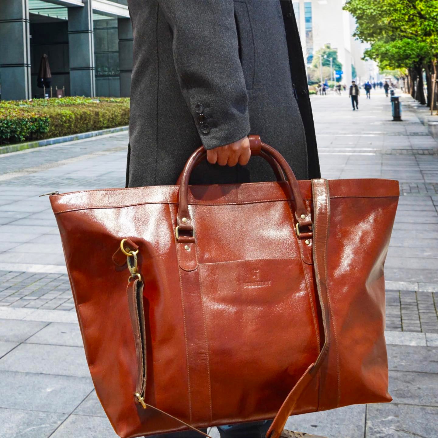 Large handmade chestnut full leather holdall made from full grain vegetable tanned cow leather. A luxury travel bag, perfect for weekend trips or longer.