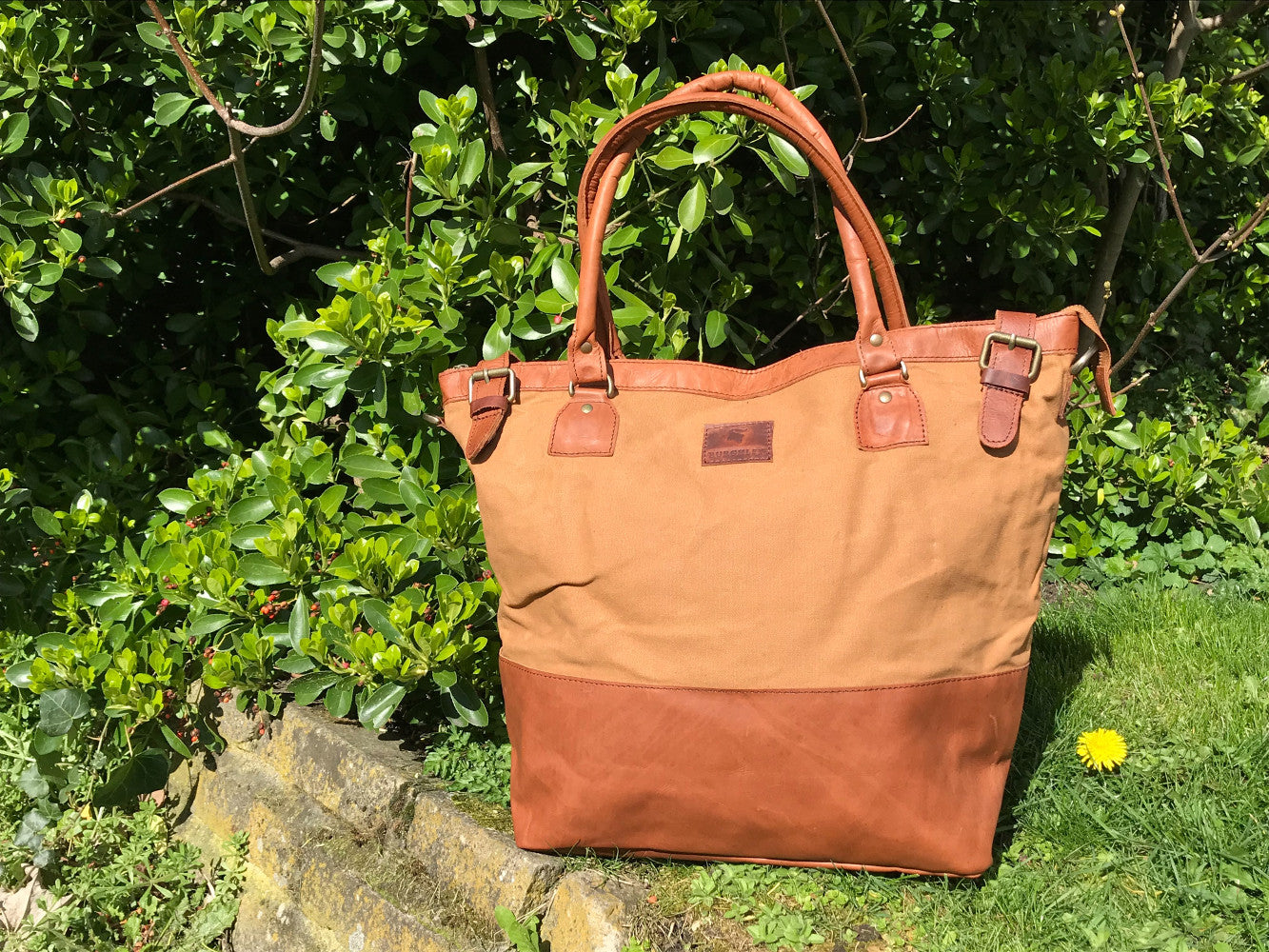 The Bingham.  A classic zipped tote bag by Burghley Bags.  Handmade from eco-friendly vegetable tanned leather and strong cotton canvas, with a leather shoulder strap.  Shown in classic tan.