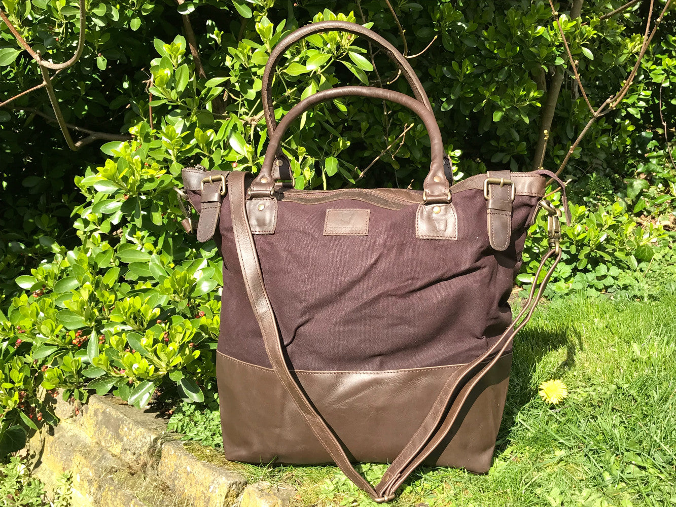 The Bingham.  A classic zipped tote bag by Burghley Bags.  Handmade from eco-friendly vegetable tanned leather and strong cotton canvas, with a leather shoulder strap.  Shown in stylish dark brown.