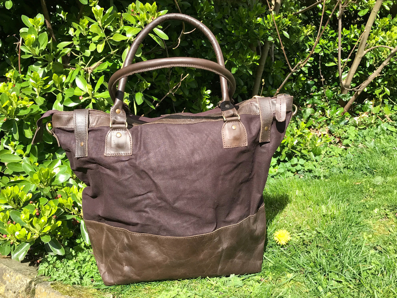 The Bingham.  A classic zipped tote bag by Burghley Bags.  Handmade from eco-friendly vegetable tanned leather and strong cotton canvas, with a leather shoulder strap.  Shown in stylish dark brown.