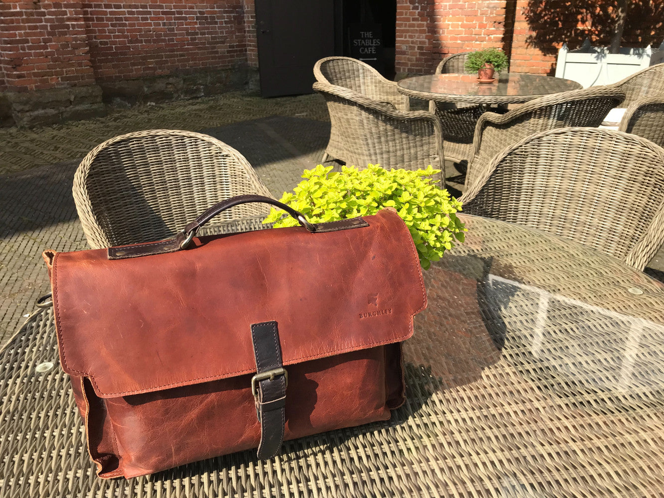 The Dorrington Briefcase. A classic 30's styled leather briefcase by Burghley Bags. A handmade leather vintage work bag, with enough space for 15" laptops. Comes with an adjustable and detachable shoulder strap. Shown in striking dual brown.