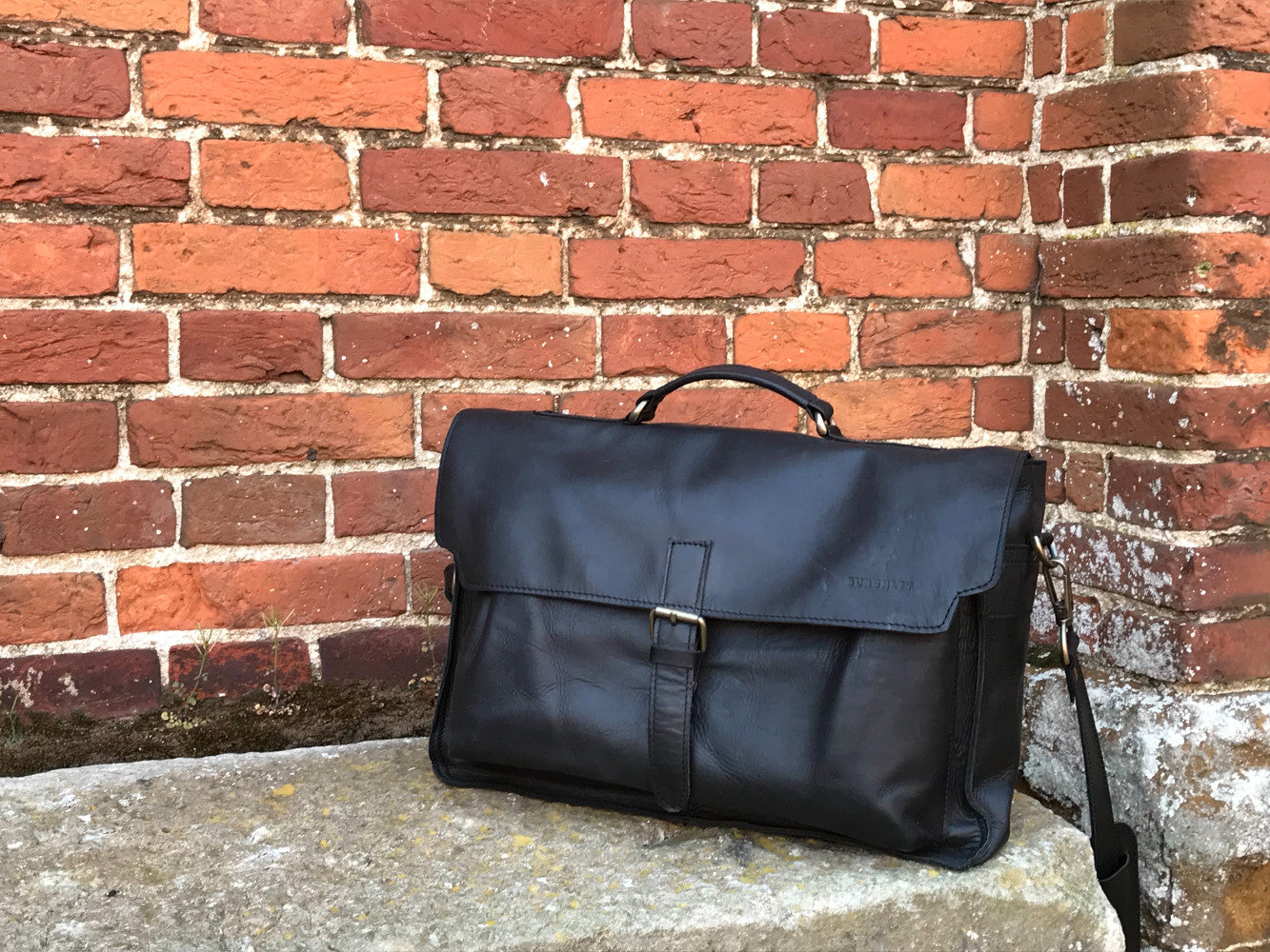 The Dorrington Briefcase. A classic 30's styled leather briefcase by Burghley Bags. A handmade leather vintage work bag, with enough space for 15" laptops. Comes with an adjustable and detachable shoulder strap. Shown in elegant black.