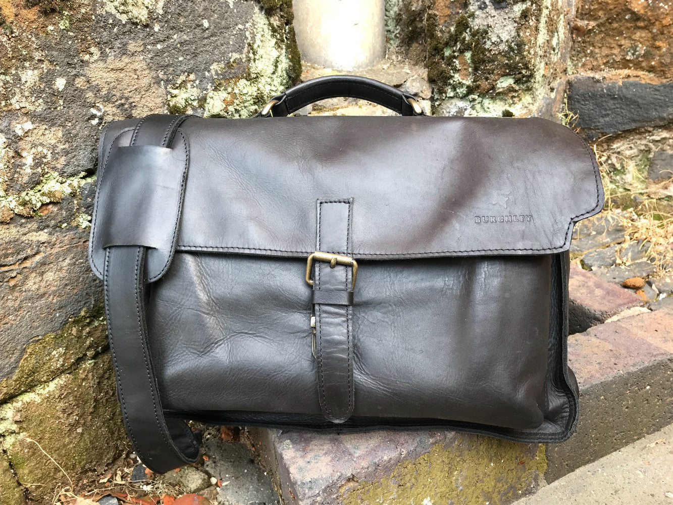 The Dorrington Briefcase. A classic 30's styled leather briefcase by Burghley Bags. A handmade leather vintage work bag, with enough space for 15" laptops. Comes with an adjustable and detachable shoulder strap. Shown in classic dark brown.