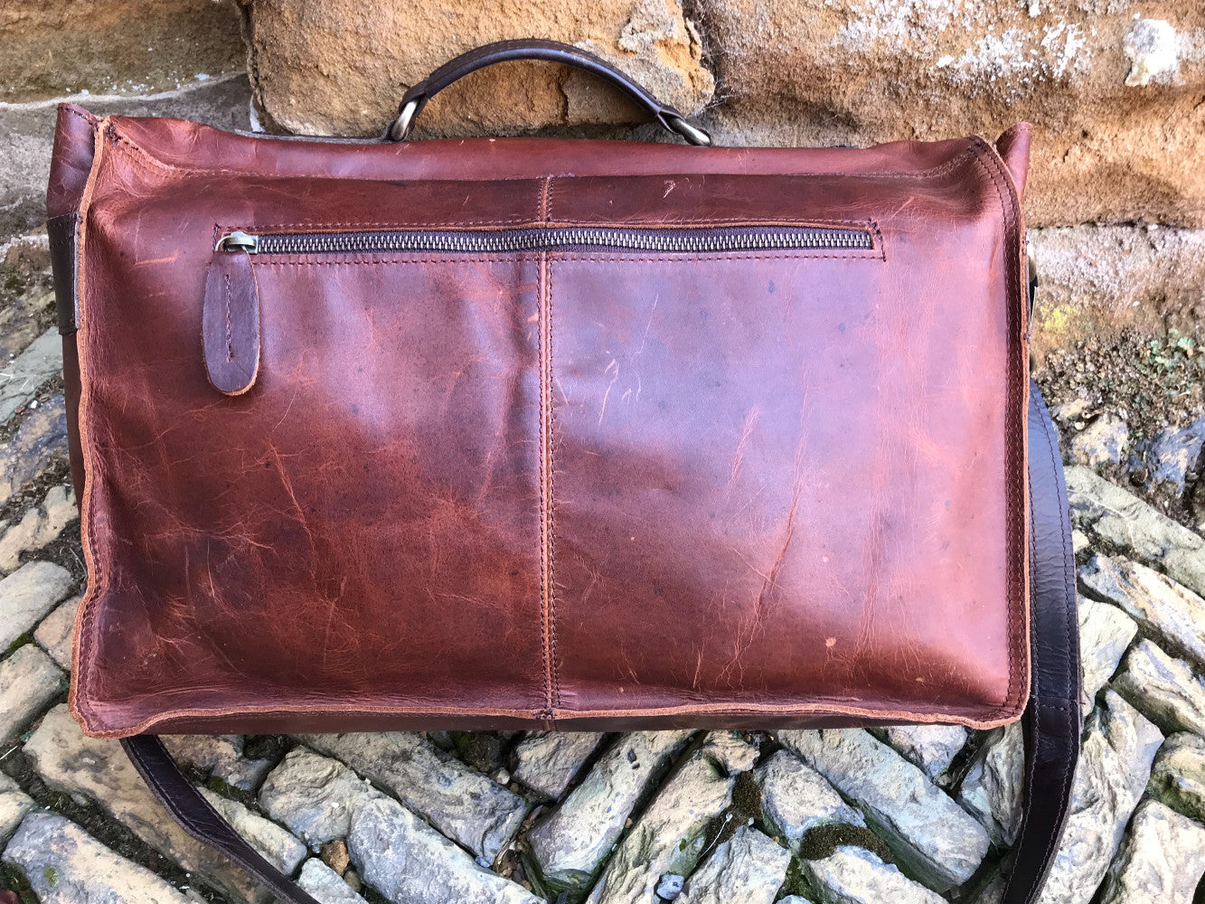 The Dorrington Briefcase. A classic 30's styled leather briefcase by Burghley Bags. A handmade leather vintage work bag, with enough space for 15" laptops. Comes with an adjustable and detachable shoulder strap. Striking dual brown back showing zip pocket.