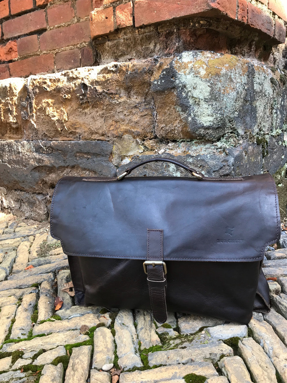 The Dorrington Briefcase. A classic 30's styled leather briefcase by Burghley Bags. A handmade leather vintage work bag, with enough space for 15" laptops. Comes with an adjustable and detachable shoulder strap. Shown in classic dark brown.